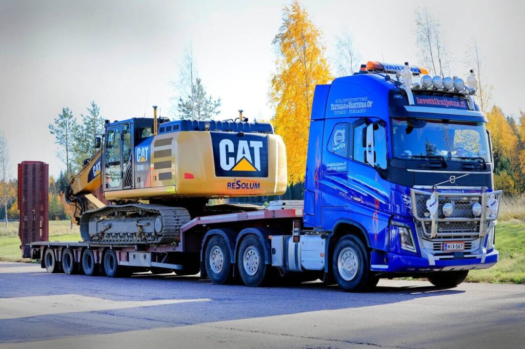 truck carrying excavator